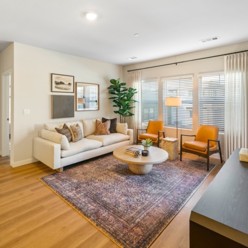 a living room with a couch and chairs