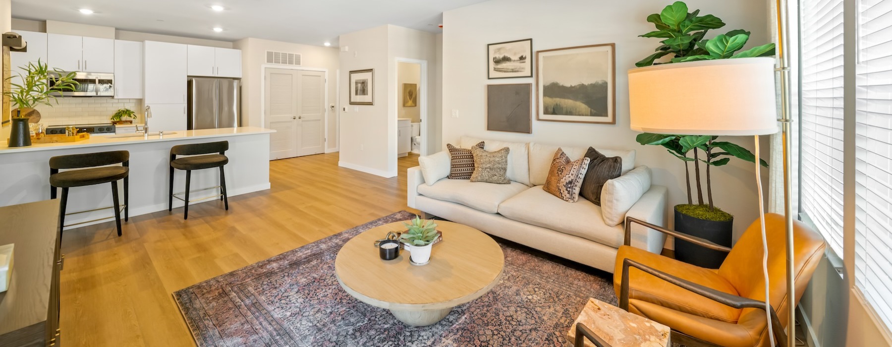 a living room with a couch, tables and chairs