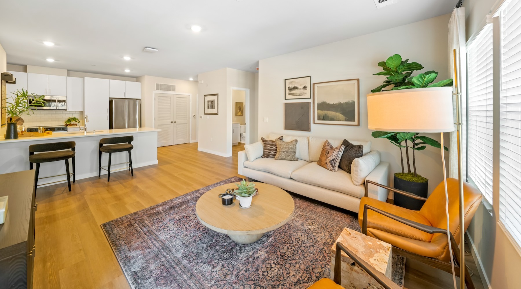 a living room with a couch, tables and chairs