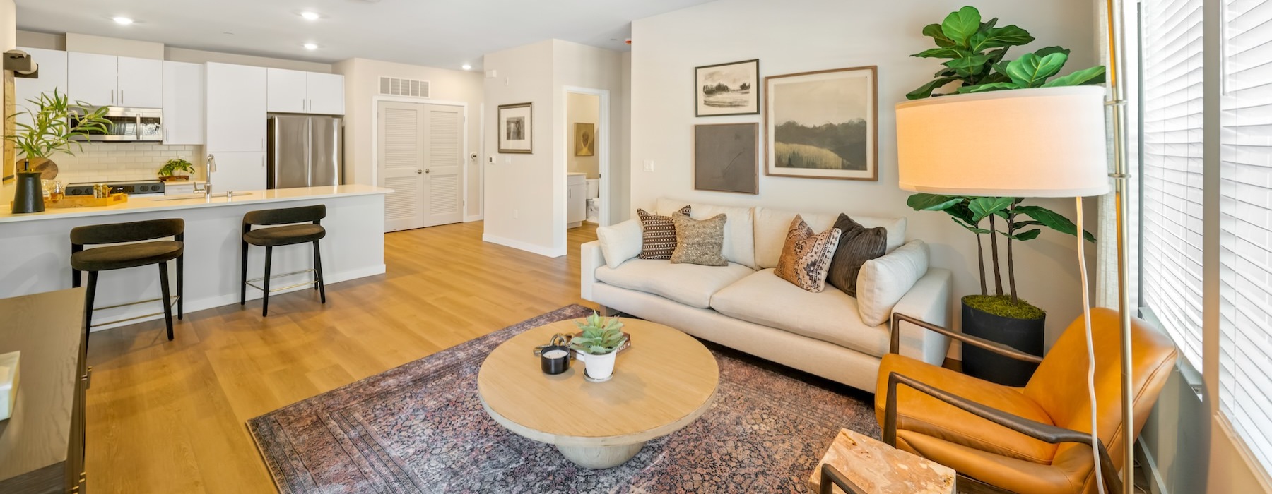 a living room with a couch, tables and chairs