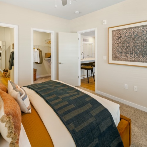 a bedroom with a bed and wall art